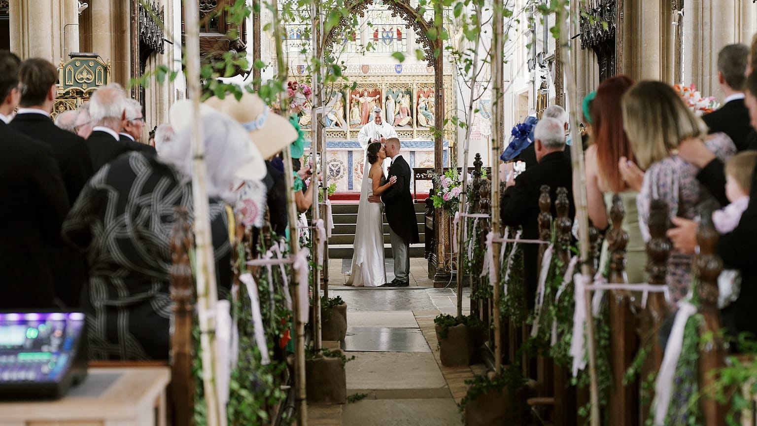 Newlyweds kissing in a church ceremony.