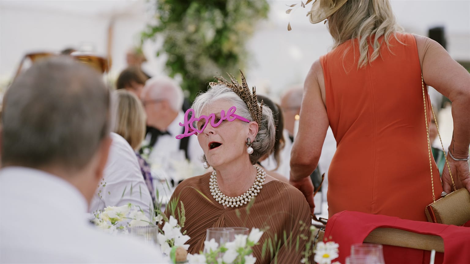 Woman wearing love glasses at festive event