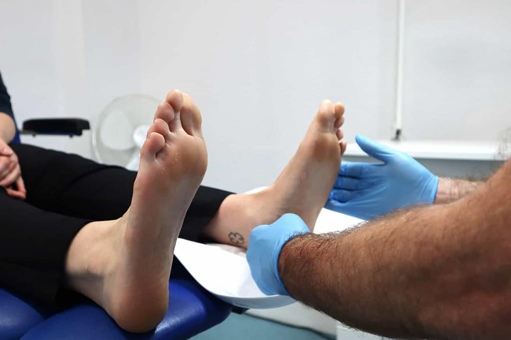 Podiatrist examining foot for Plantar Fasciitis