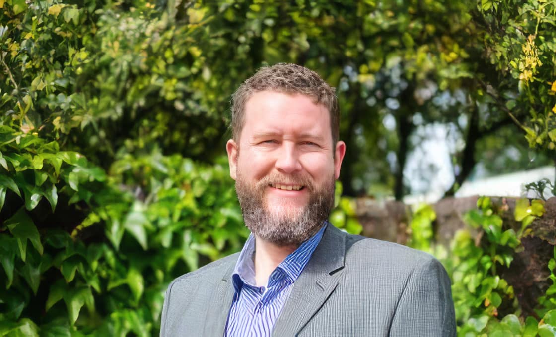 Smiling man outdoors in a suit jacket