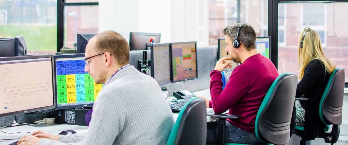 Office employees working at computer desks