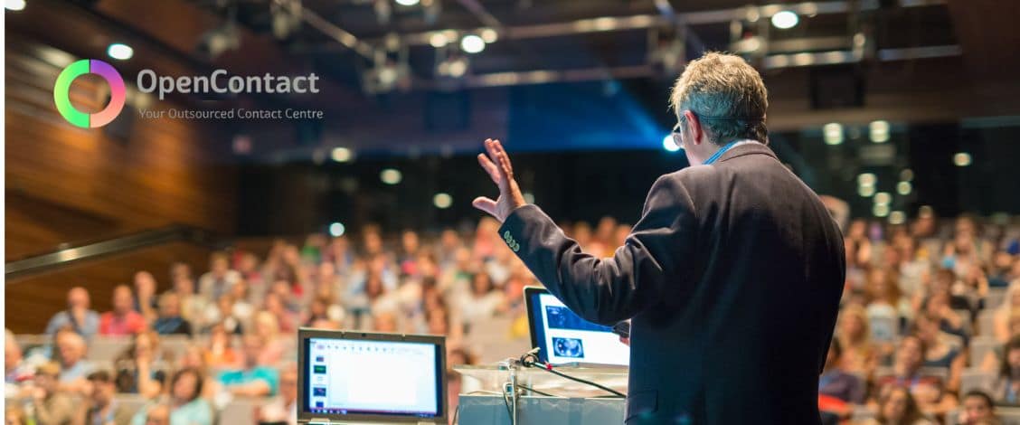 Speaker presenting to audience at OpenContact event