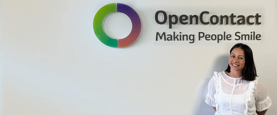 Woman smiling beside OpenContact company logo