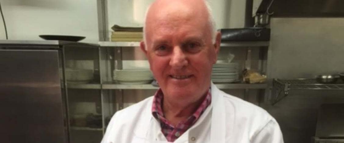 Chef smiling in a professional kitchen