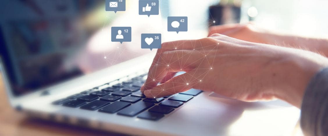 Person using laptop for social media engagement