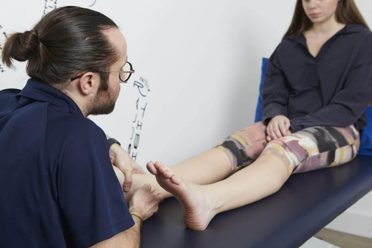 Podiatrist examining patient's foot