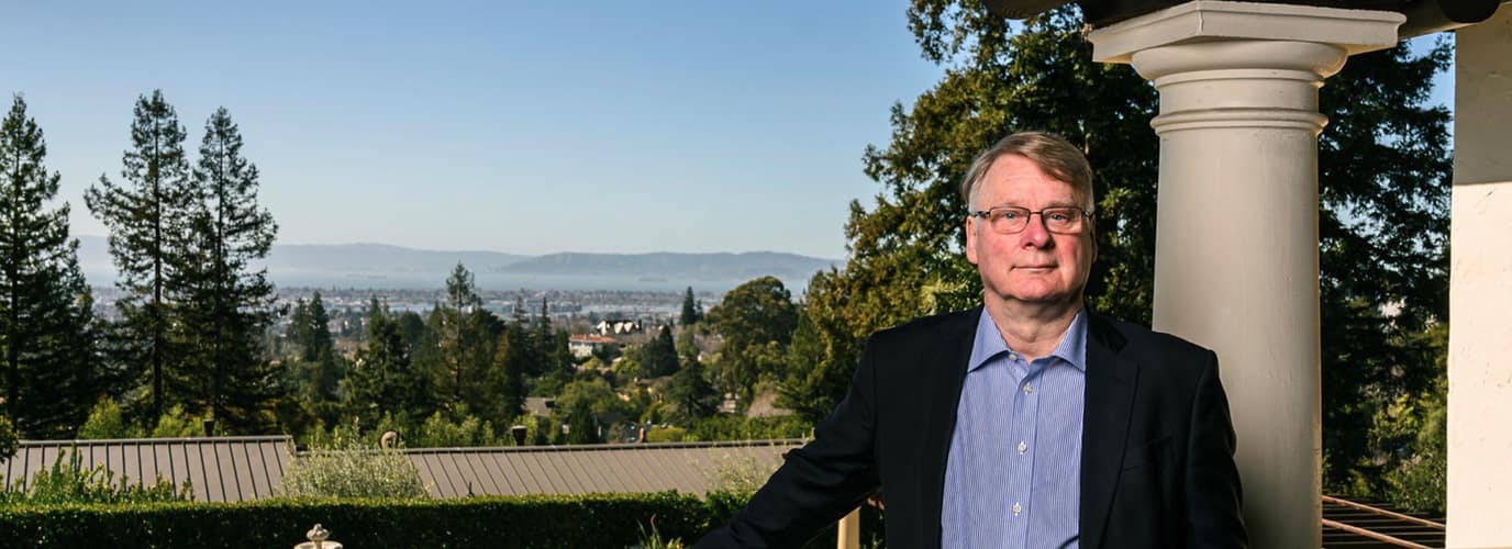 Man standing outdoors with scenic landscape view
