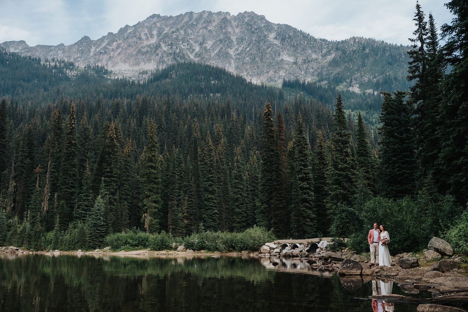 Mountain scenery with couple by a forested lake Gibson.