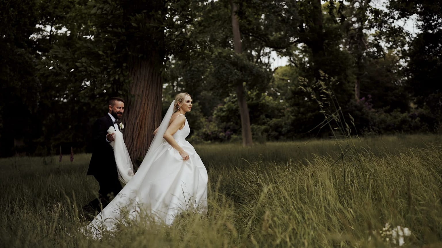 Bride and groom walking in forest wedding scene