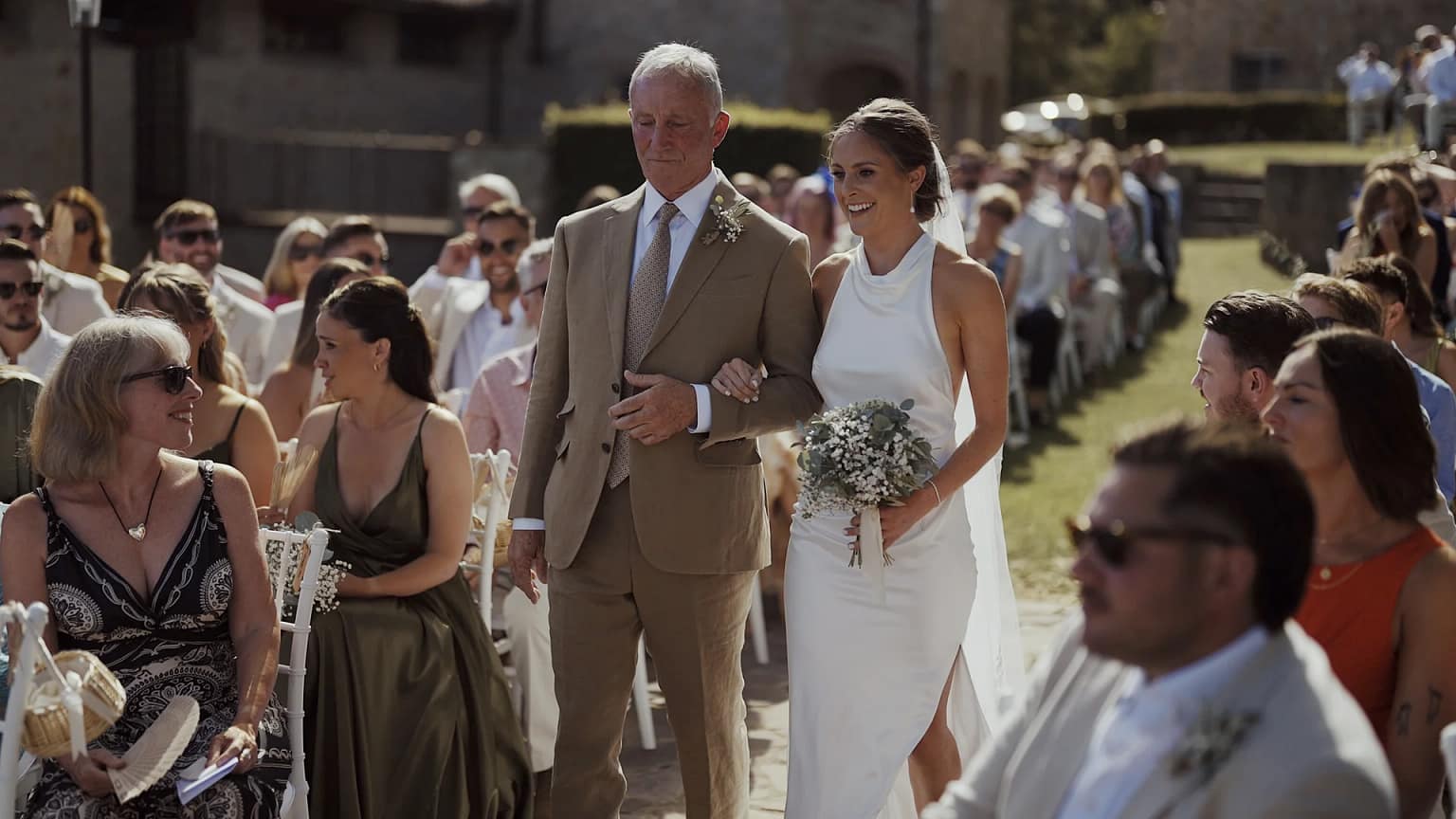Bride walking down aisle with elder gentleman