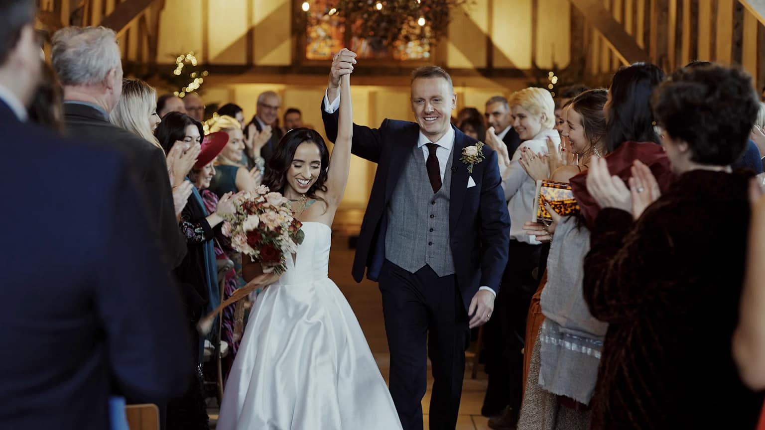 Bride and groom joyful exit, guests applauding
