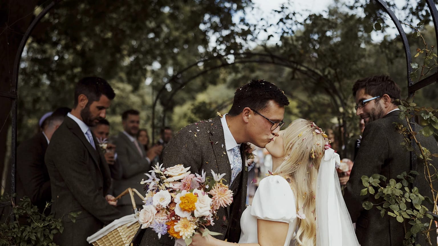 Bride and groom kissing at outdoor wedding ceremony