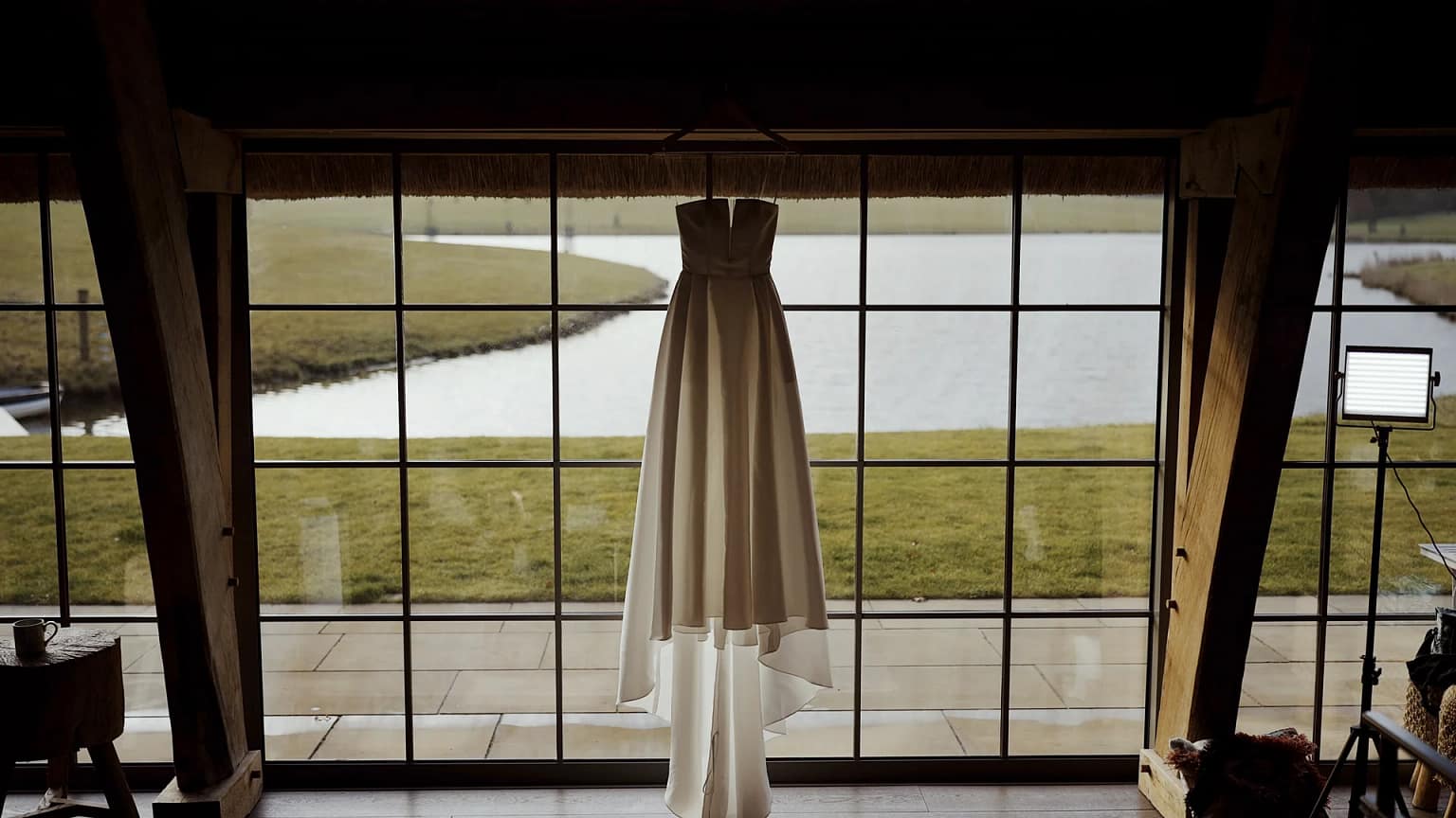 Elegant wedding dress by large window view