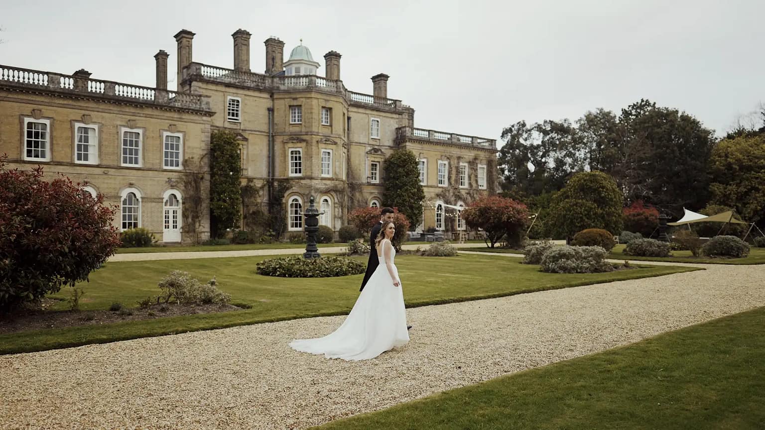 Bride and groom at elegant manor garden