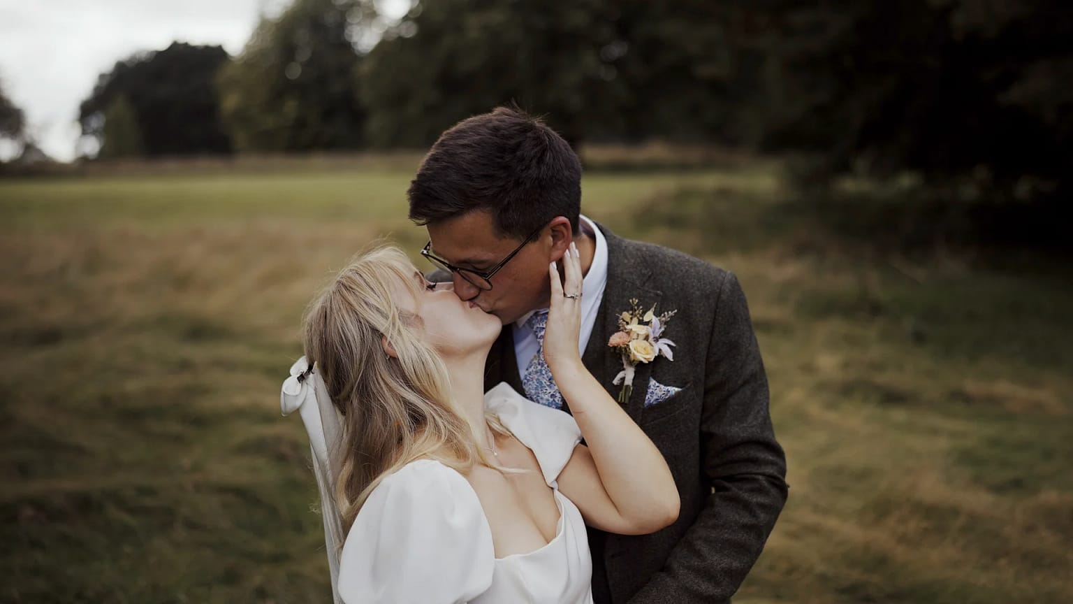 Bride and groom kissing outdoors