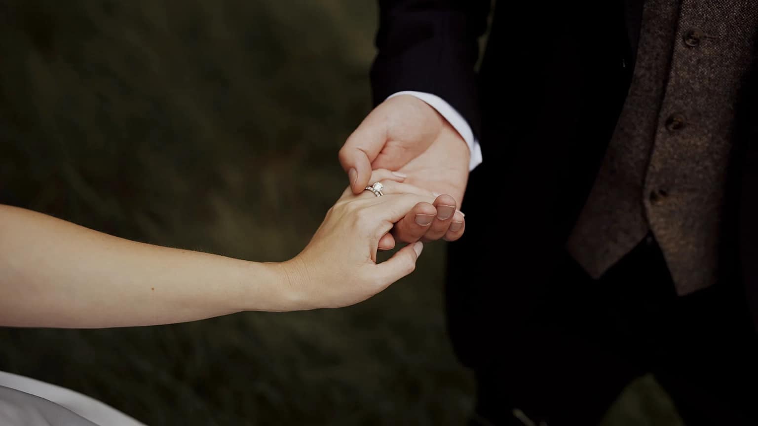 Close-up of couple holding hands with rings