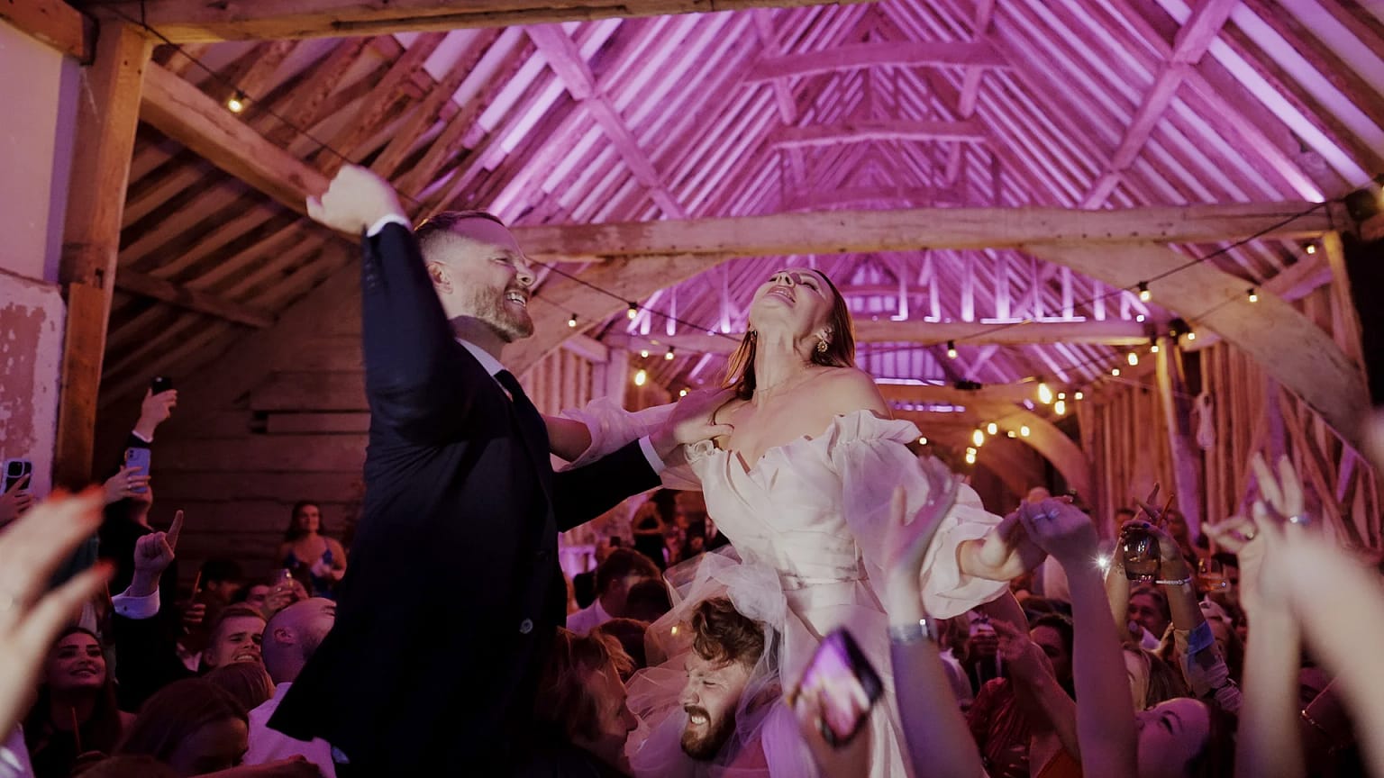 Bride and groom celebrate at lively wedding reception.
