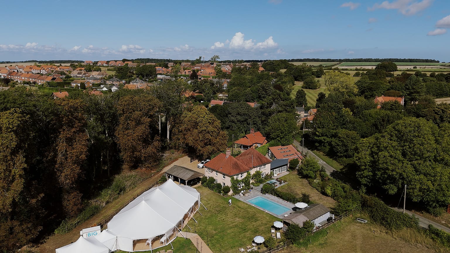 Aerial view of countryside house with marquee