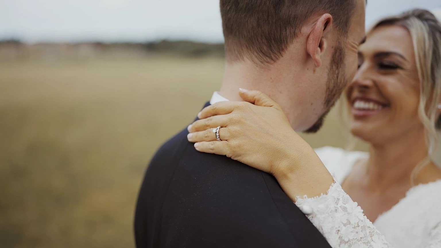 Close-up of couple embracing with smiles.