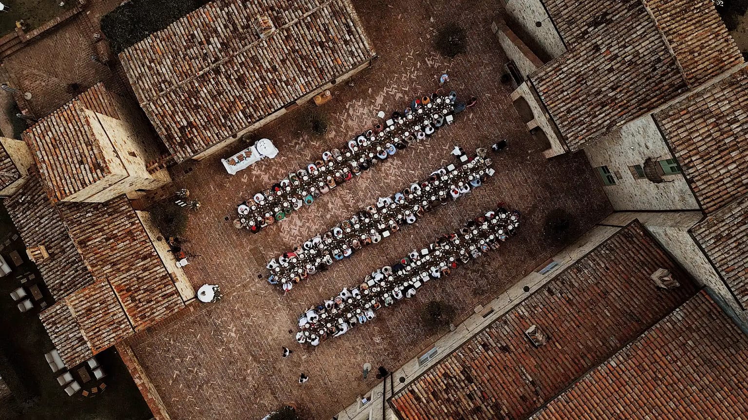 Aerial view of outdoor dining in rustic courtyard.