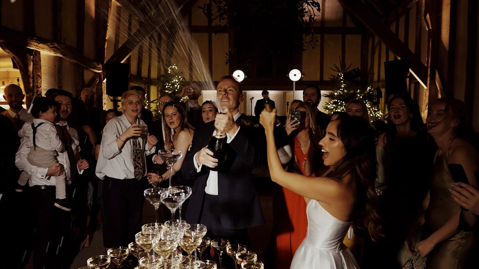 Celebratory champagne spraying at a wedding party.