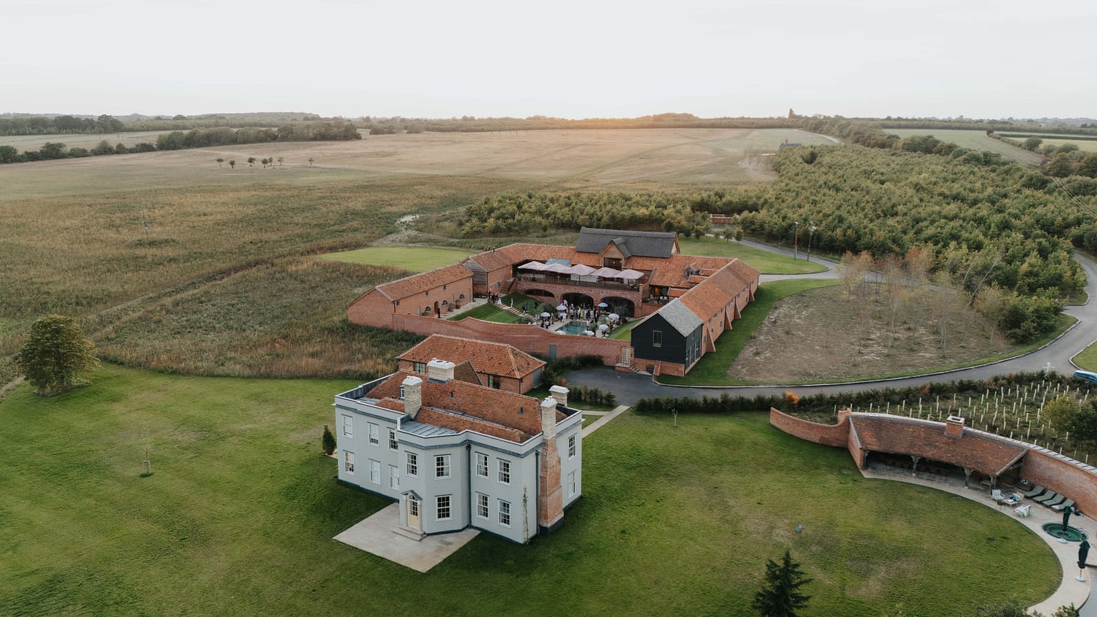 Aerial view of rural estate with red rooftops.