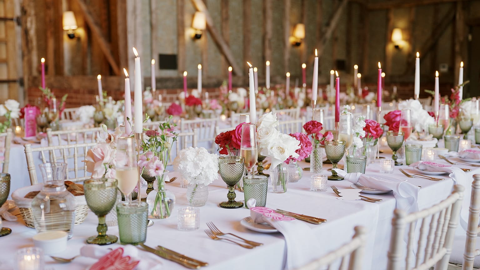 Elegant wedding reception table with flowers and candles.