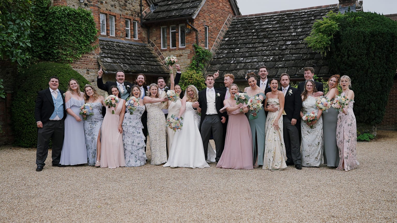 Joyful wedding party group photo outdoors