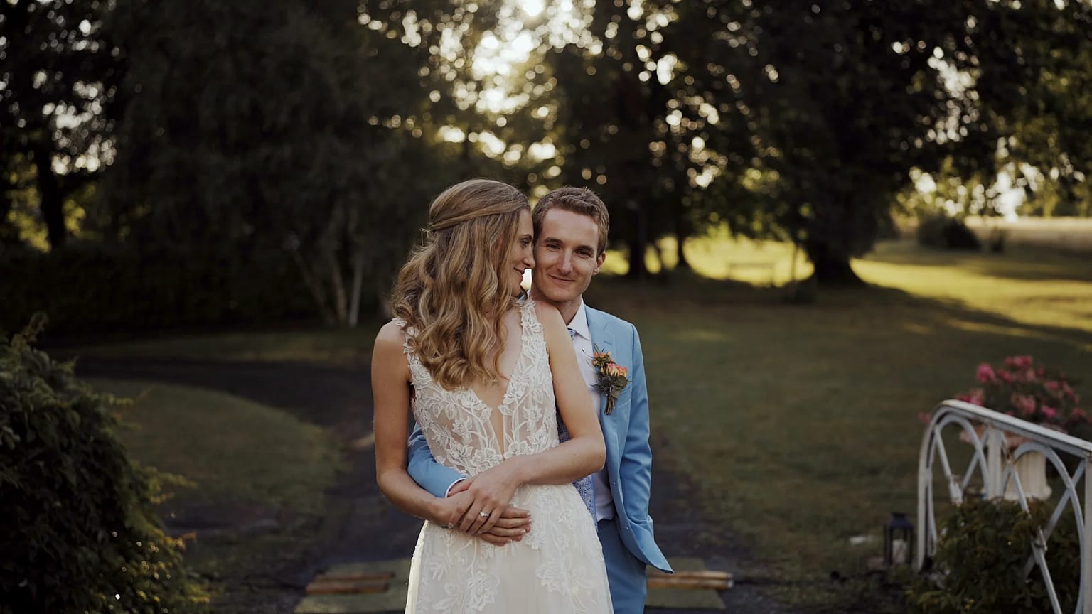 Bride and groom in garden embrace