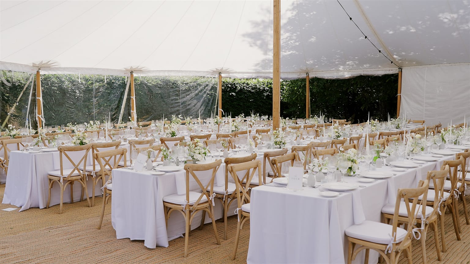 Elegant wedding reception setup in a marquee tent.