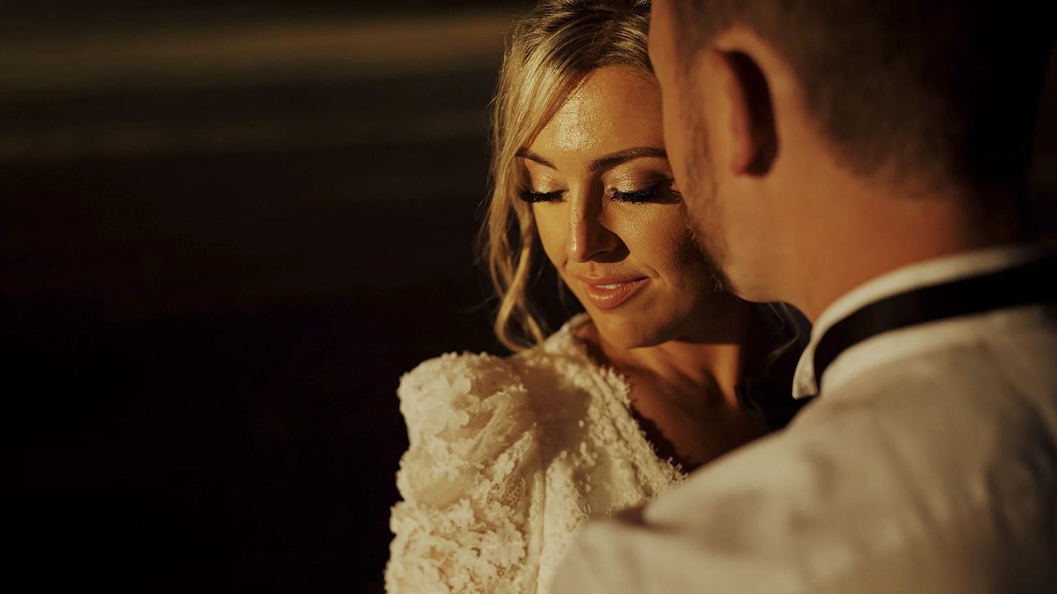 Bride and groom embracing at sunset