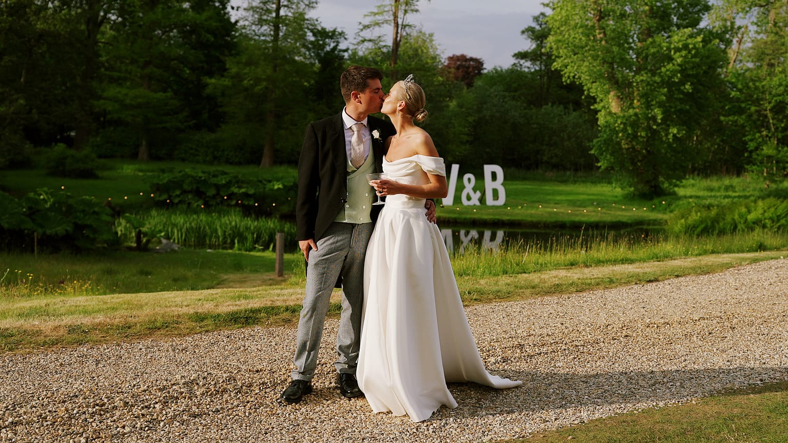 Bride and groom kissing outdoors during golden hour