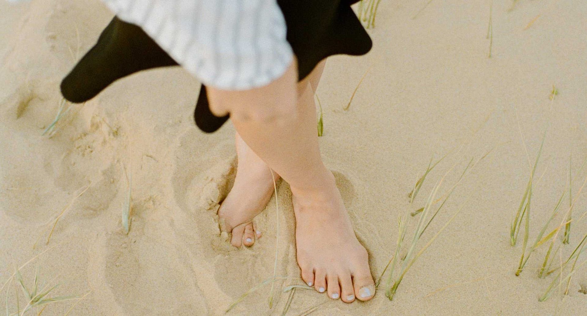 Ladies feet in the sand