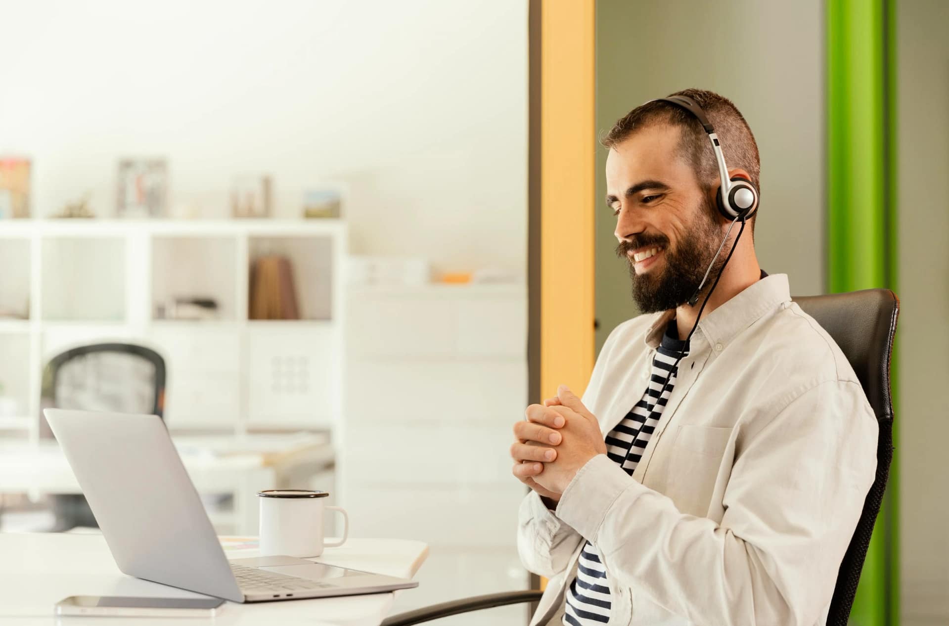 Man smiling during video call at desk