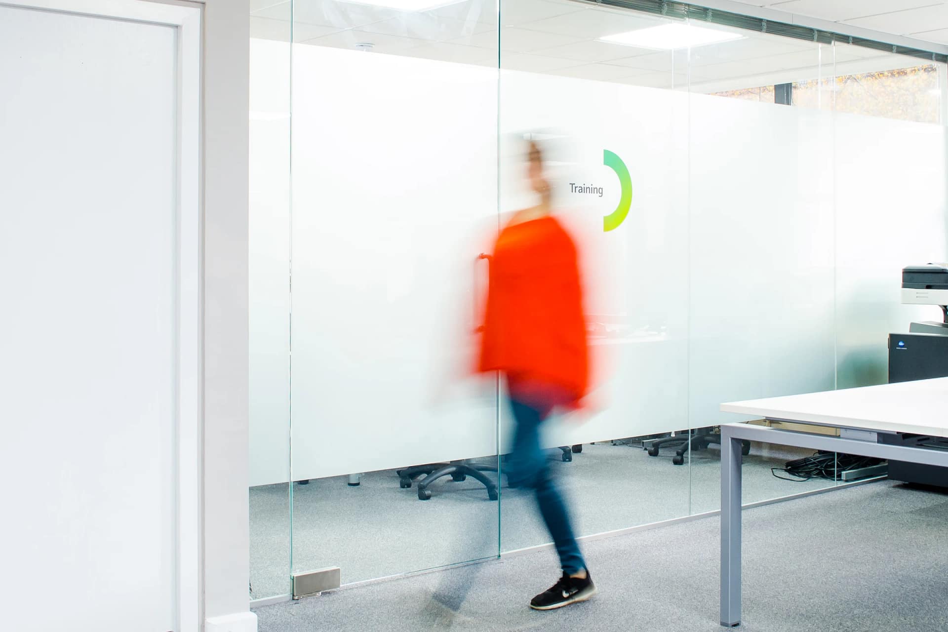 Person walking past office training room