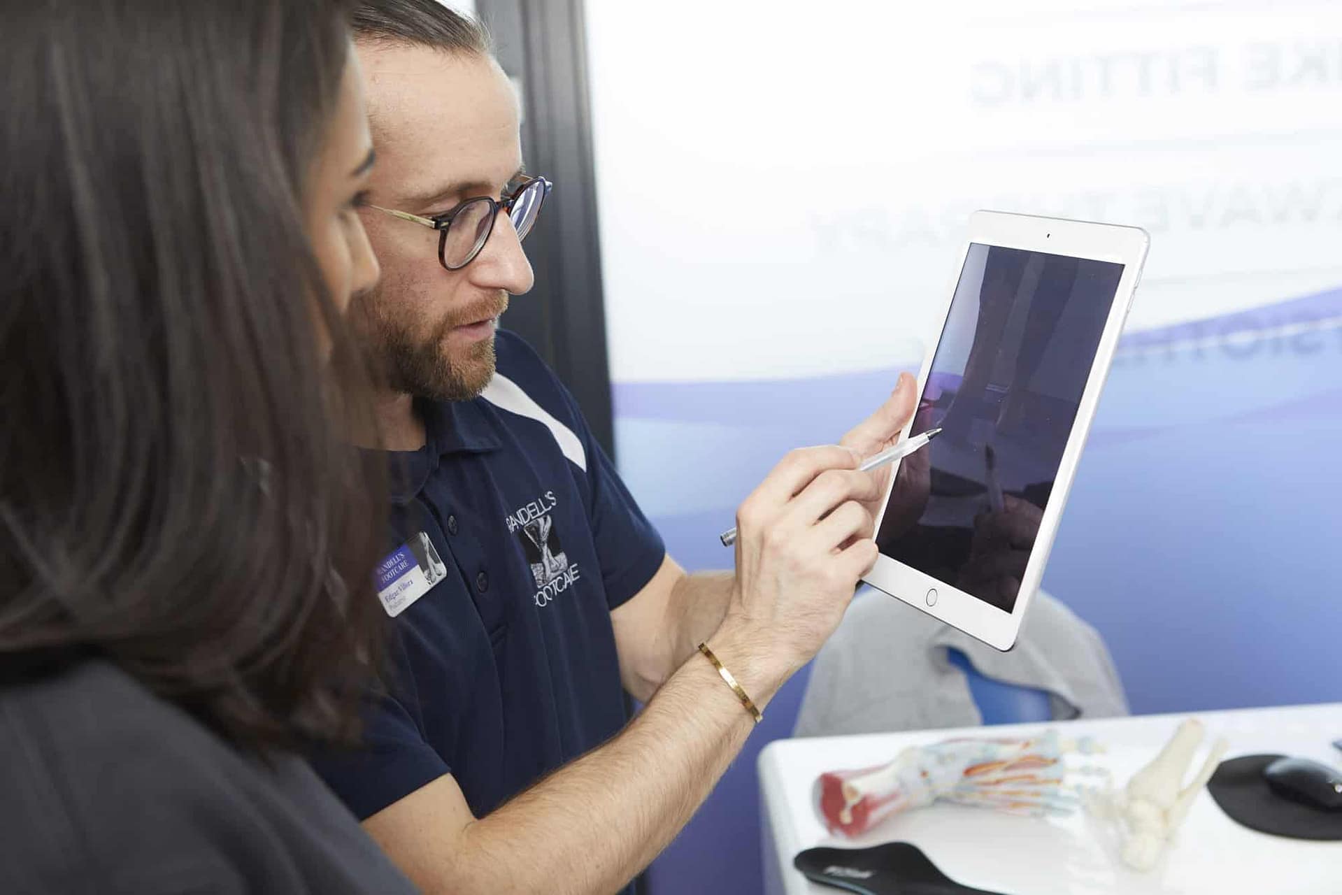 podiatrist showing patient Ipad screen