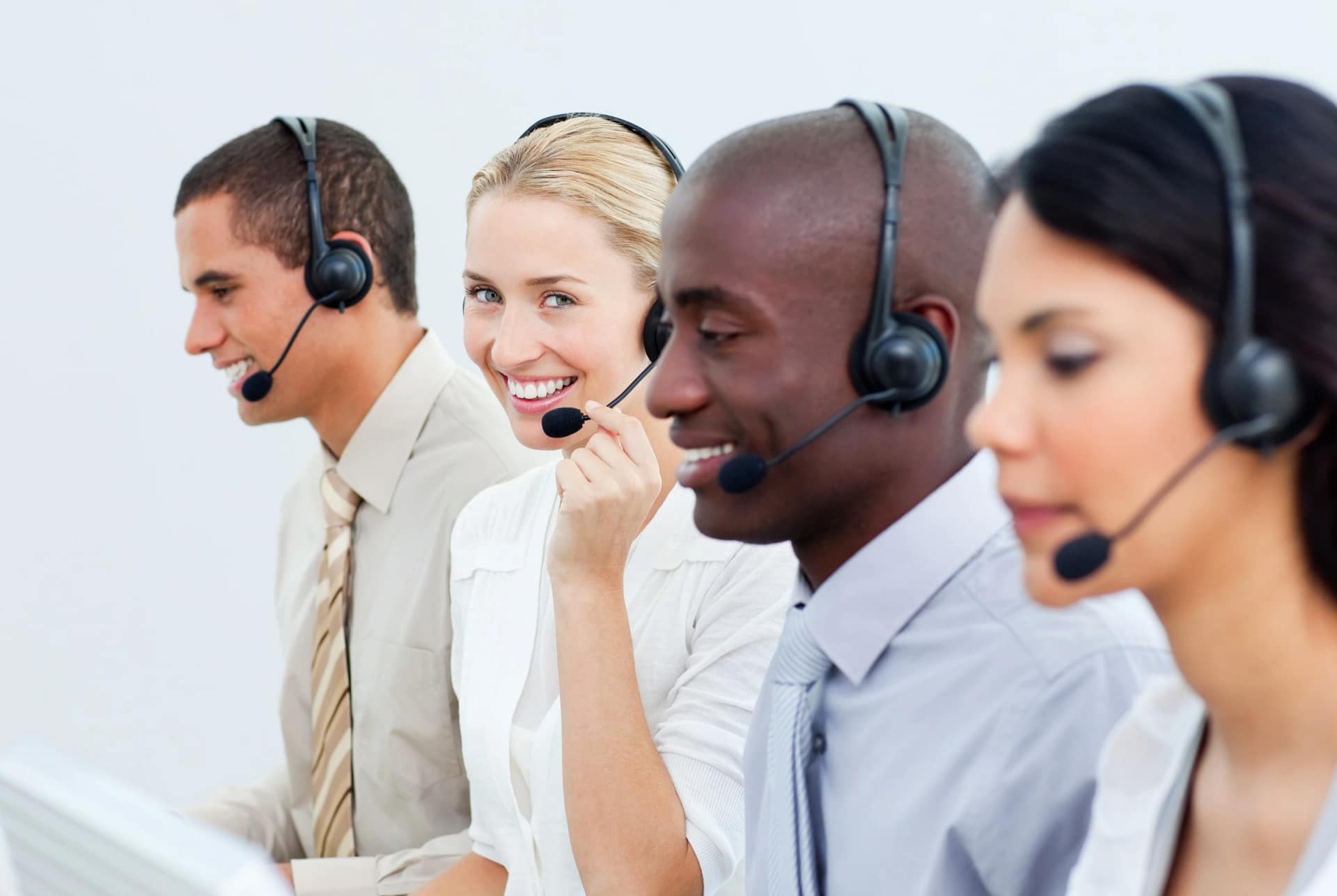 Customer service team wearing headsets at work
