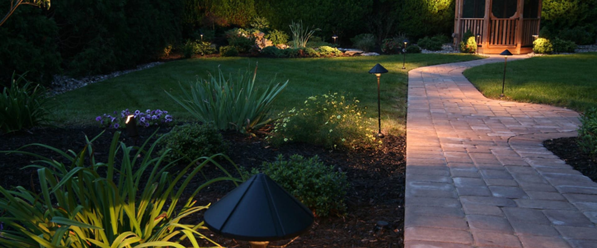 Garden pathway with outdoor lighting at night