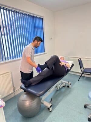 Physiotherapy examination to patient lying prone