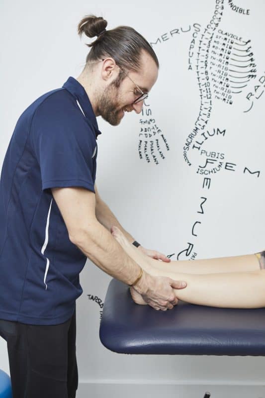 Podiatrist holding patients ankles together