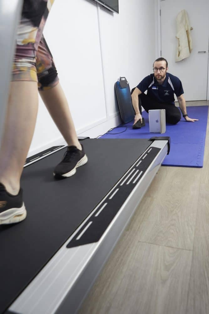 Podiatrist recording patient on a treadmill