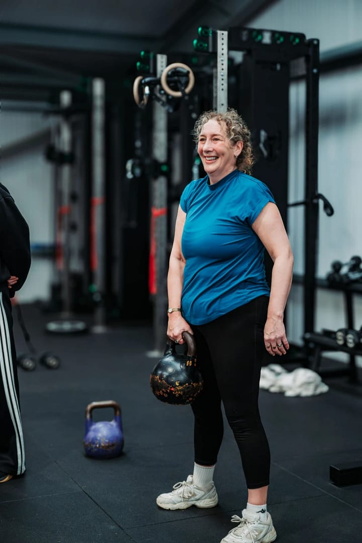 Woman holding kettlebell in gym workout session
