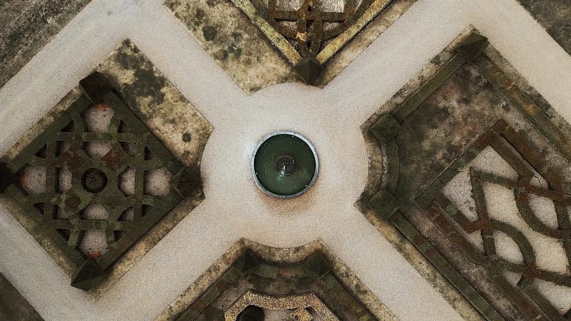 Aerial view of geometric garden pathways and fountain.