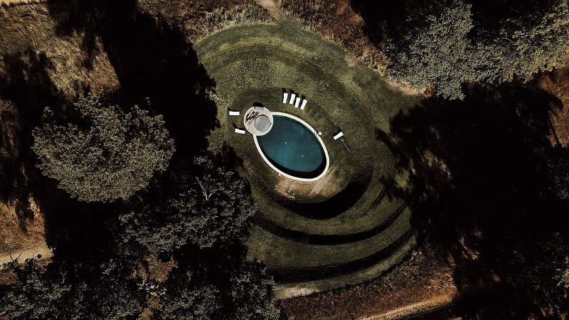 Aerial view of oval pool with chairs