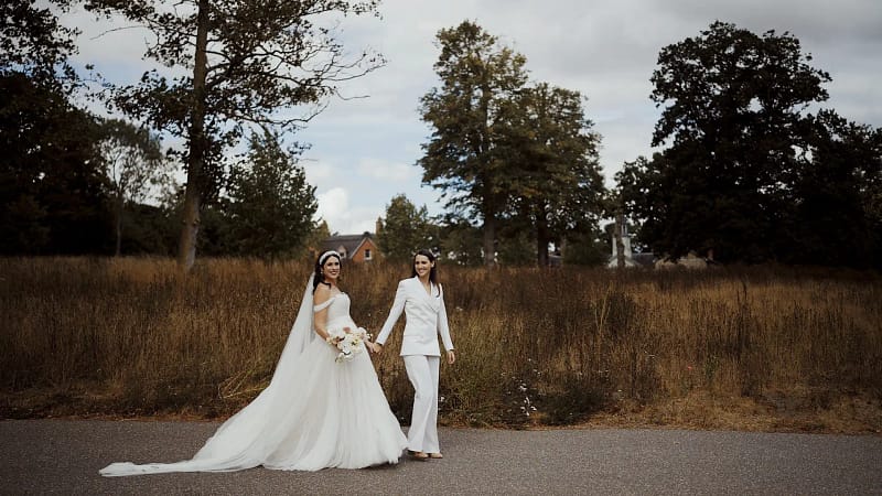 Outdoor wedding photo of couple holding hands
