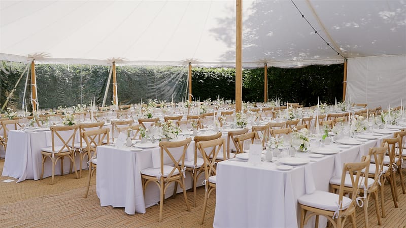Elegant wedding reception setup in a marquee tent.
