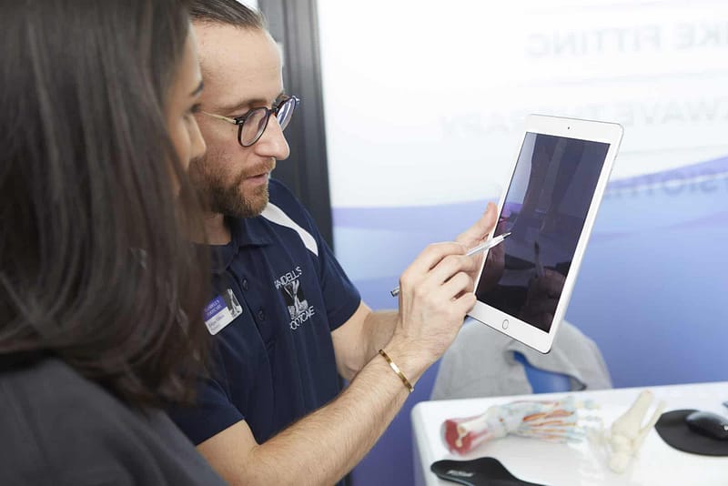 podiatrist showing patient Ipad screen