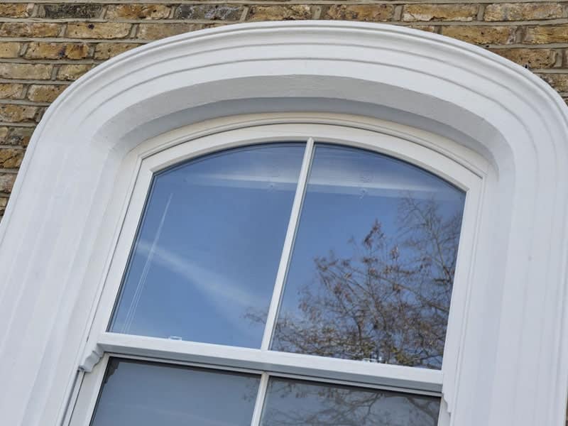 Vertical sliding window with arch